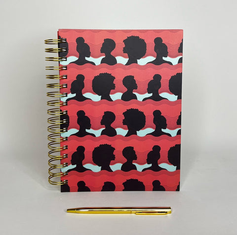 Spiral notebook with silhouettes of African American Women in Positive Peach color with gold pen