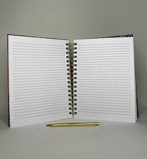 Spiral Notebook opened to show lined inner pages with elegant gold pen