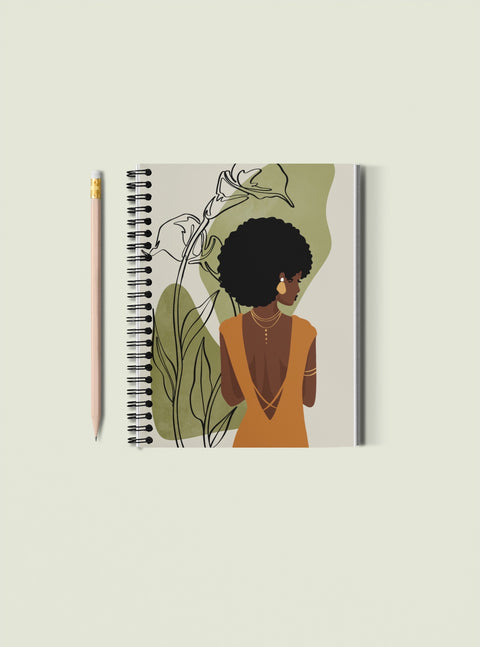 spiral bound notebook with image of elegant Black woman gracefully looking over her shoulder, pictured on plain background with wooden pencil 