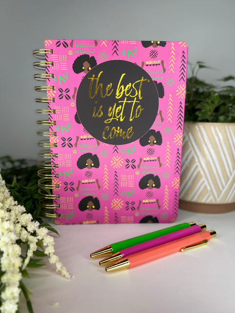 Pink spiral bound notebook with trendy African American girl patterned cover and 3 colorful ballpoint pens
