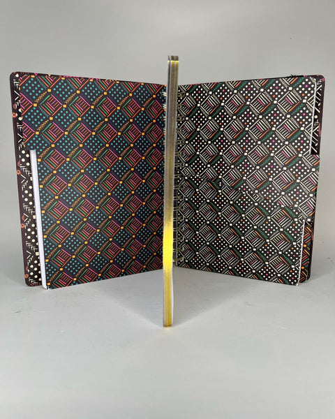 Open notebook showing African tribal print 3 subject dividers. Notebook page lined with gold foil trim