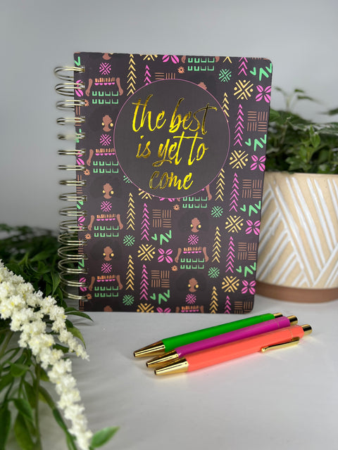 Black spiral bound notebook with trendy African American girl patterned cover and 3 colorful ballpoint pens